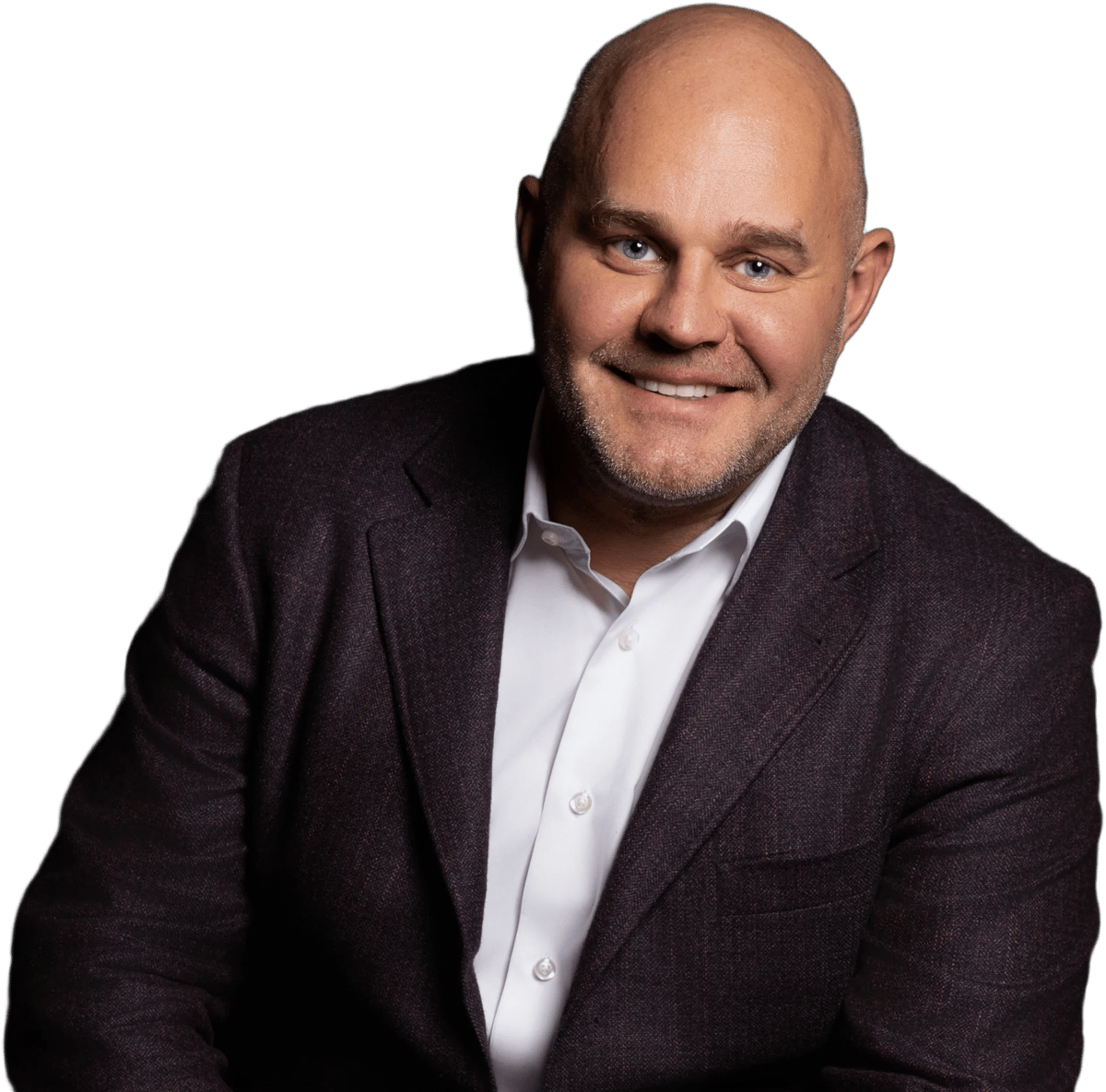 Saul Zenkevicius smiling in a dark tweed blazer