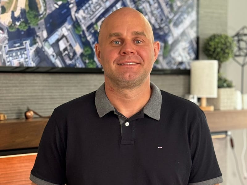 Saul Zenkevicius smiling in his office