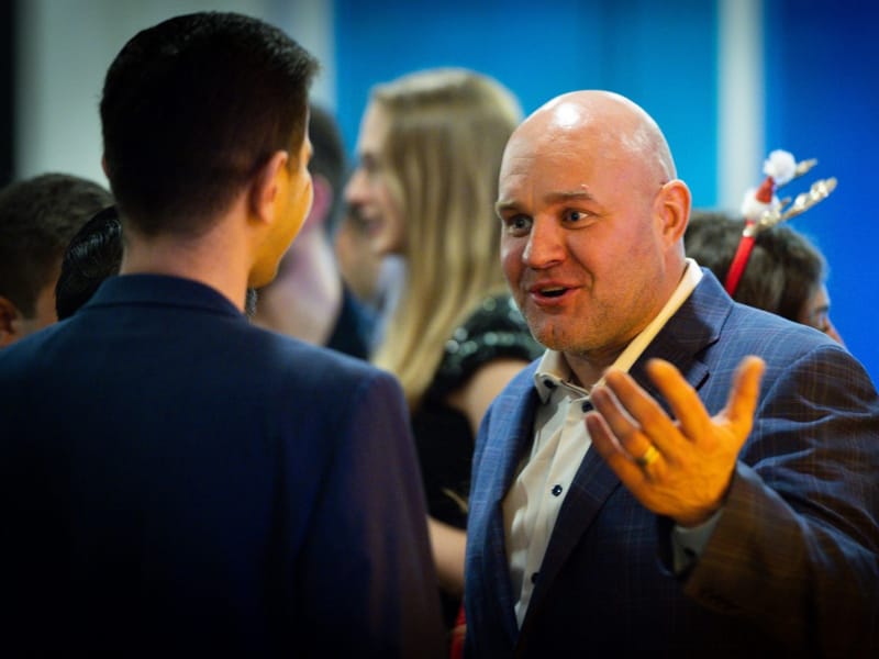 Saul Zenkevicius talking with guests at an event