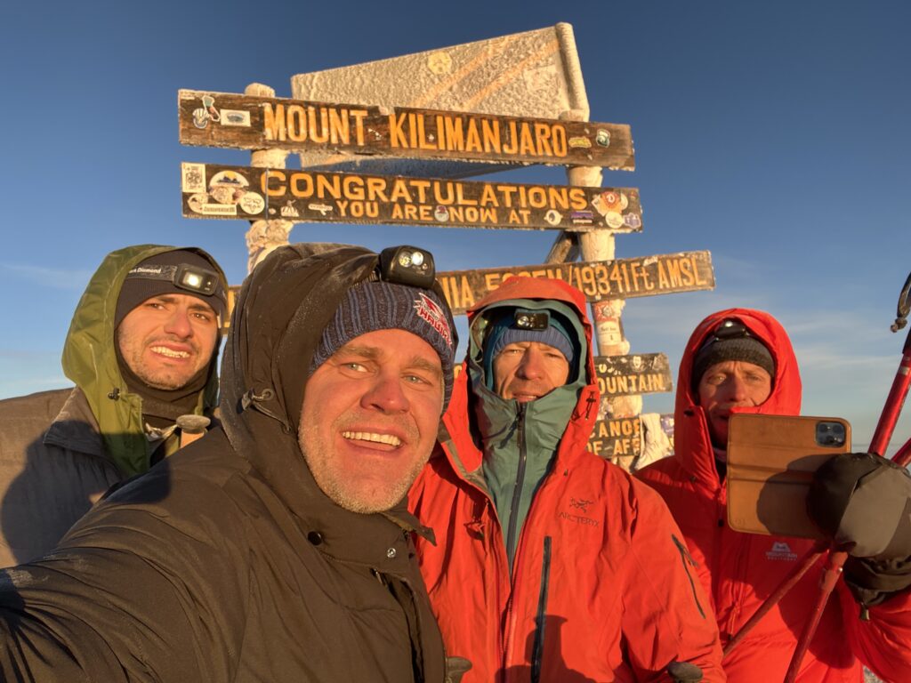 team photo on top of Mount Kilamanjaro